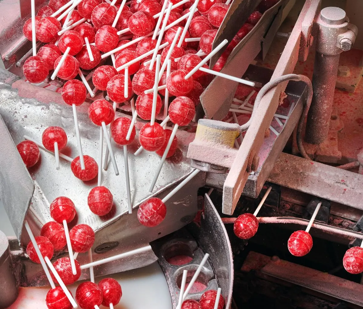 Red lollipops pouring down the Sweetannia production line